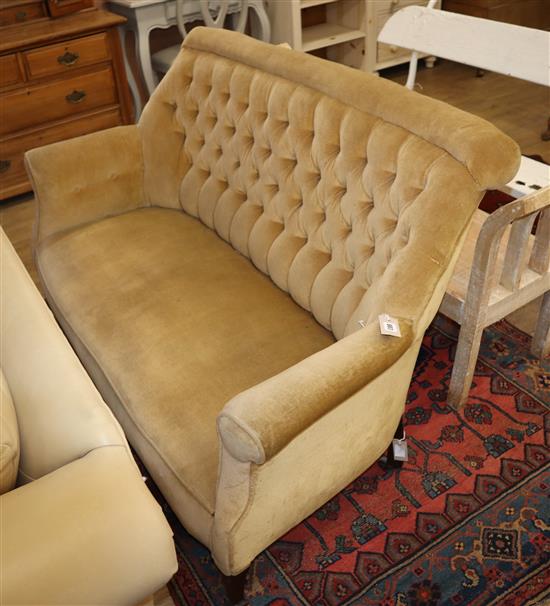 An Edwardian two seater sofa, upholstered in buttoned gold dralon